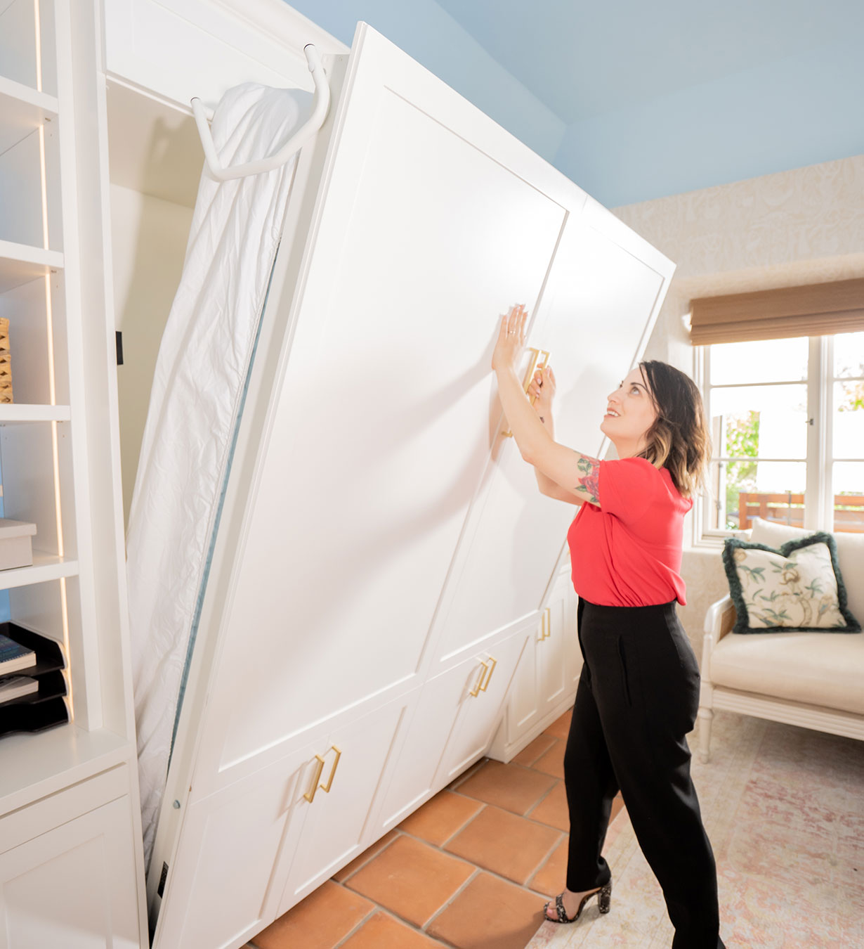 Stacy opens the wall bed