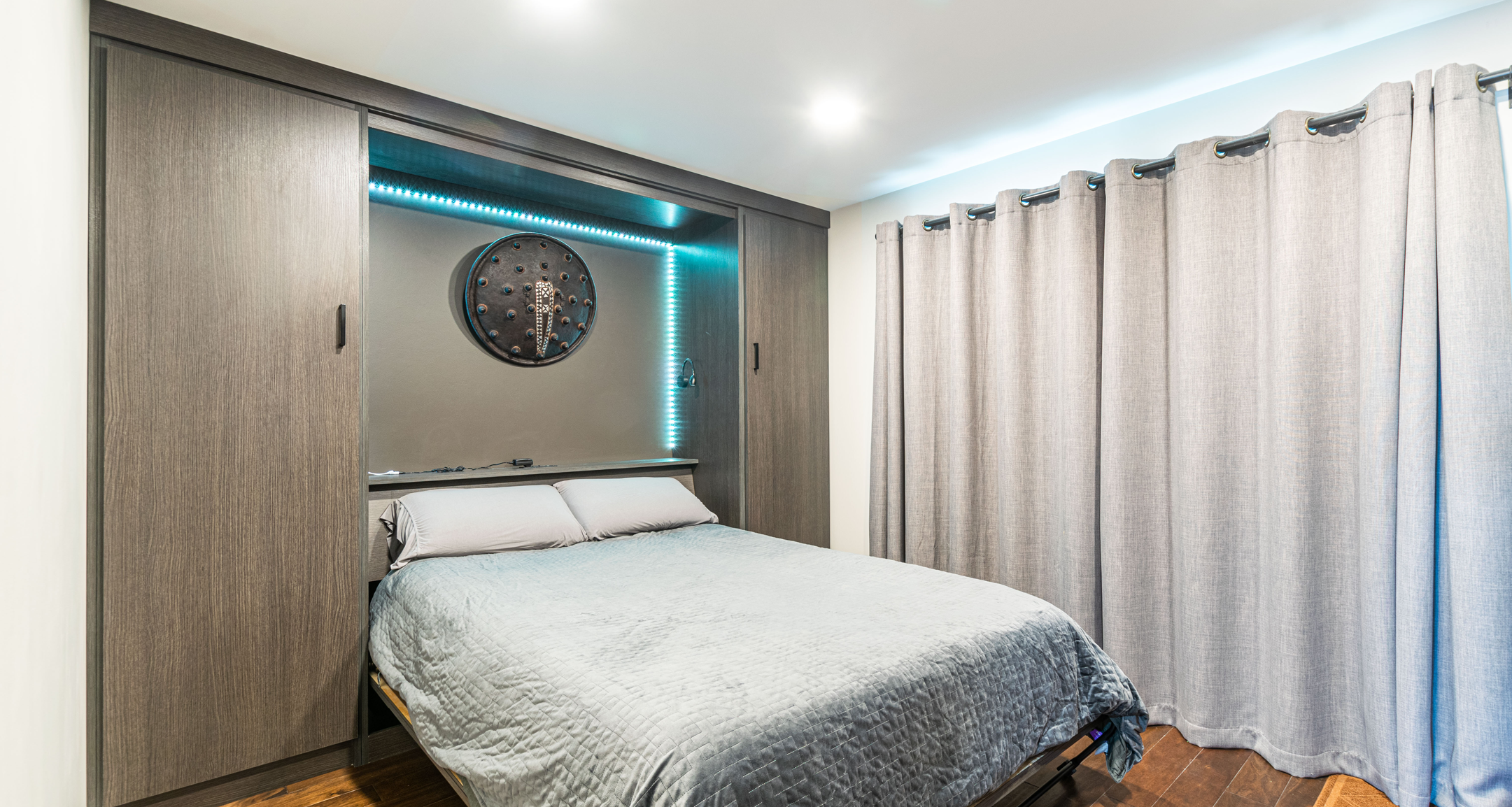Gray custom wall bed that is open